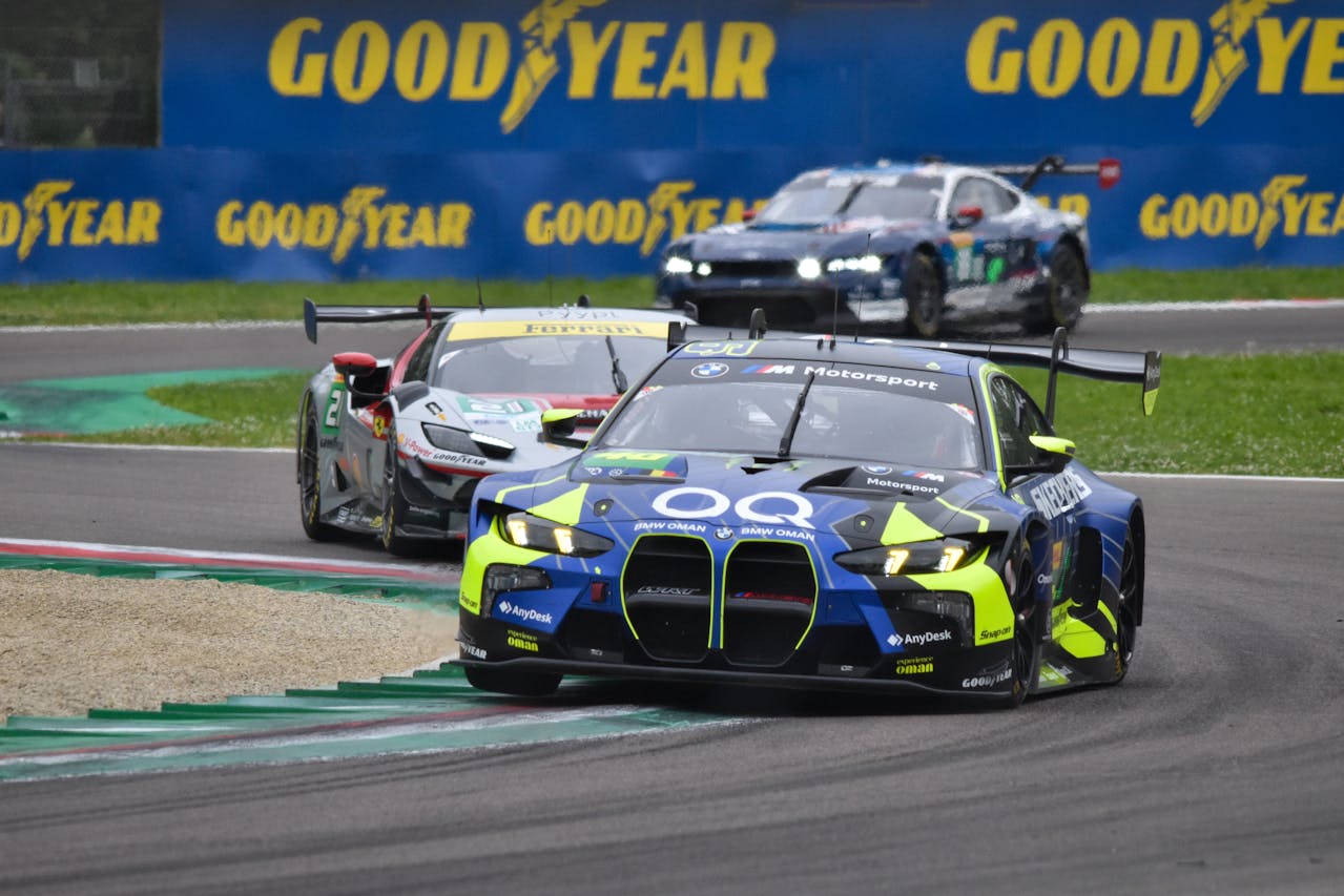 Race cars are seen circling a track