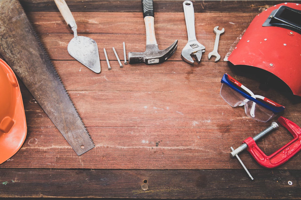 Close up of various tools on a wooden surface>