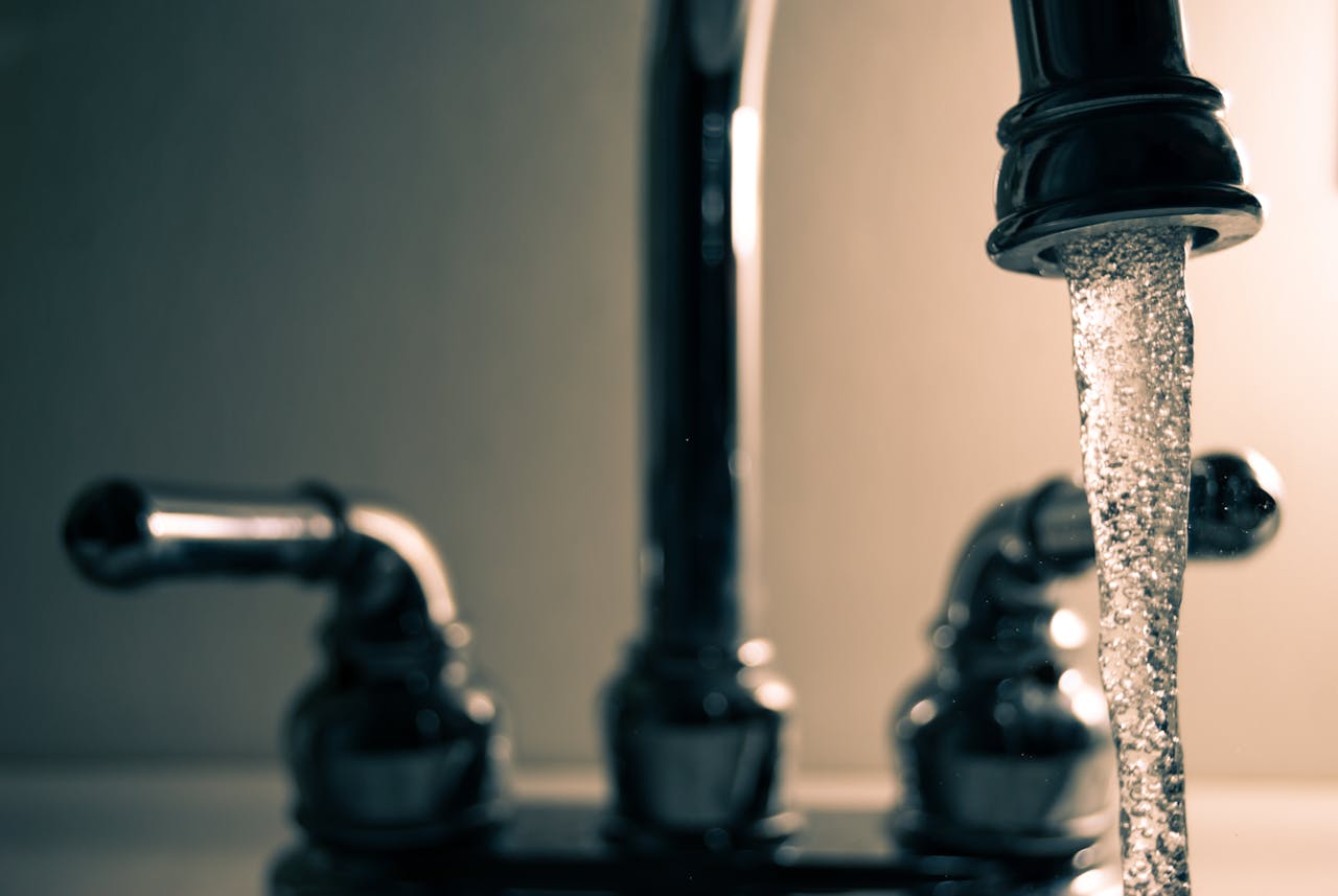 Close up of a chrome running faucet