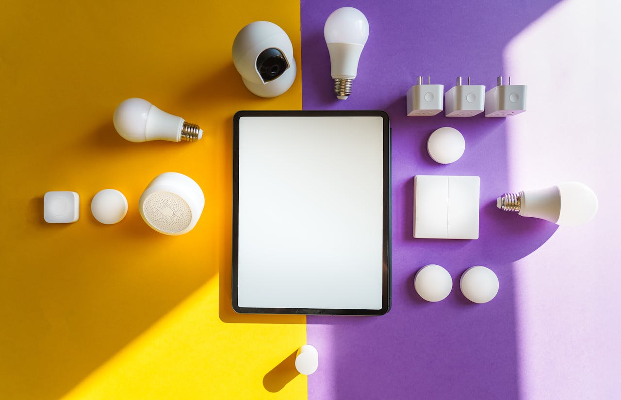 A tablet surrounded by smart plugs and lightbulbs against a purple and yellow background