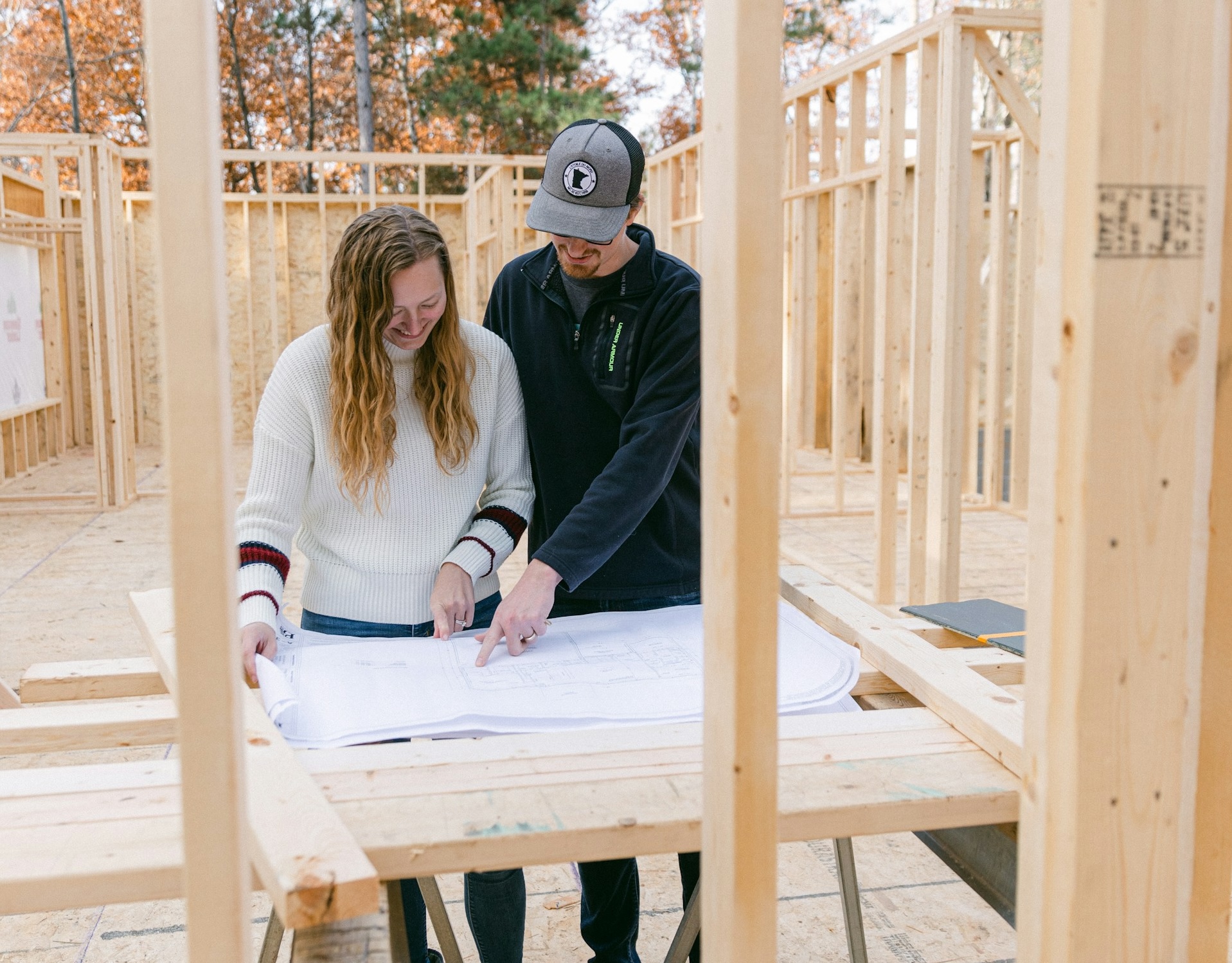 Couple reviewing plans and getting ready to build a home.>
