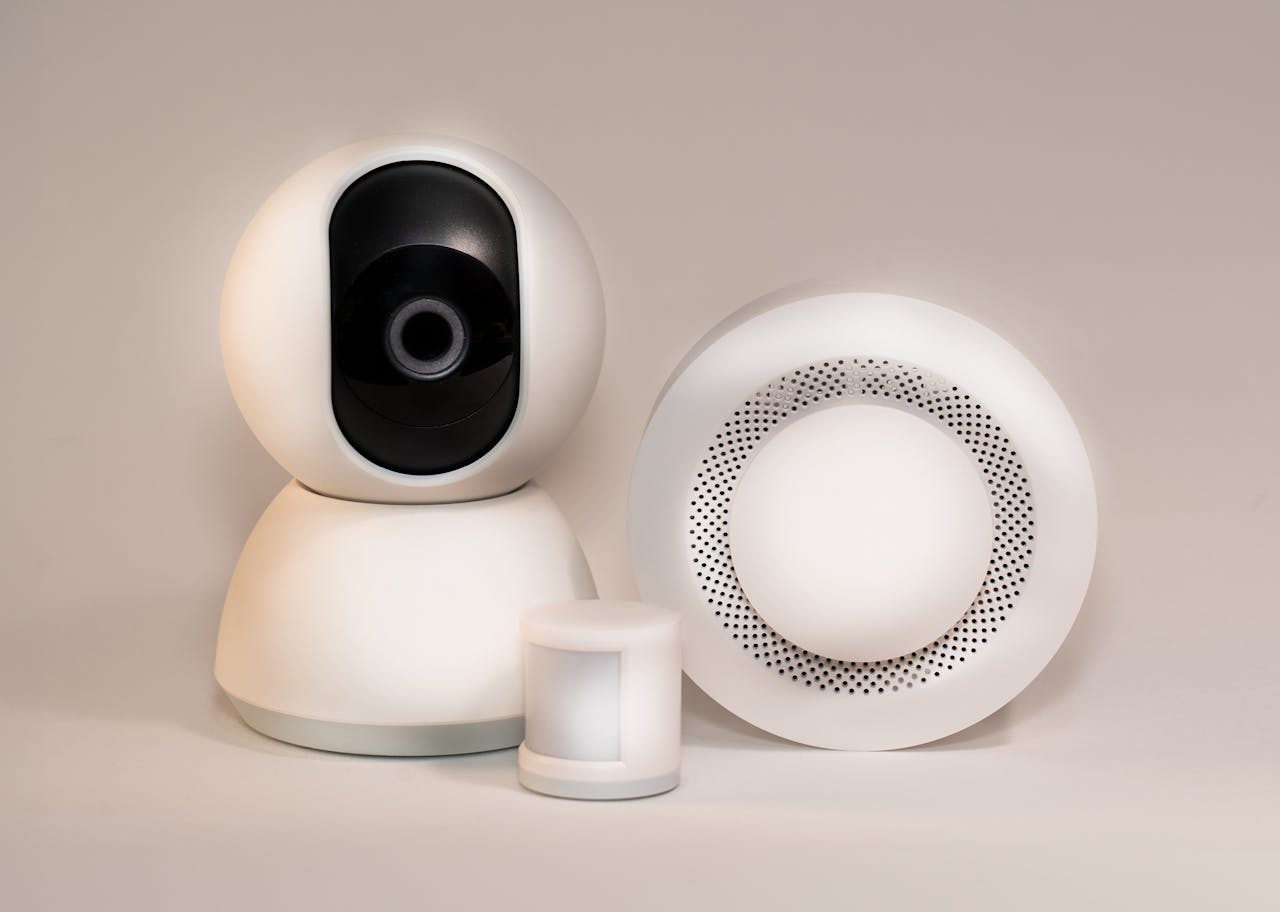 Smart camera and speakers are shown against a light background
