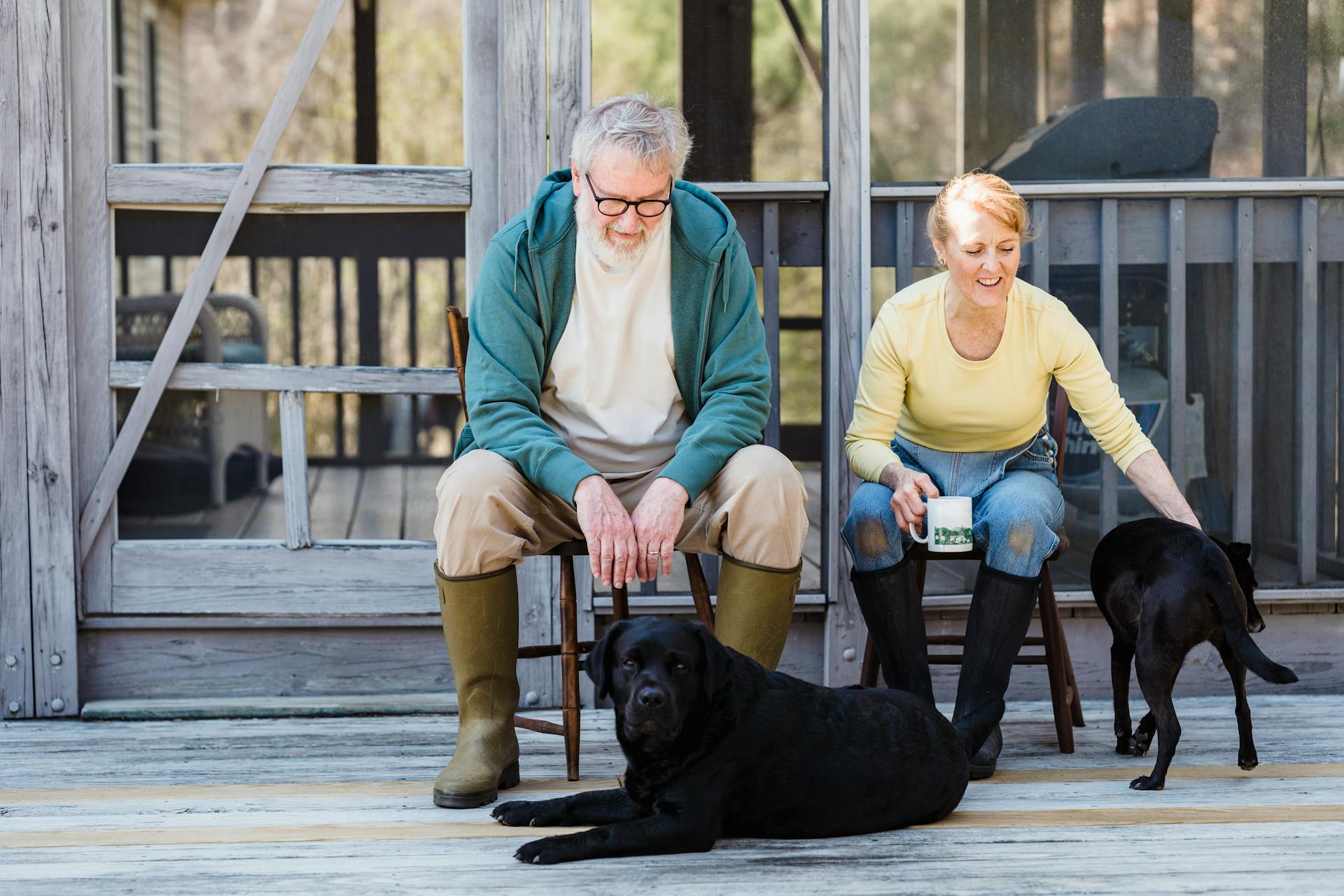 Couple outside on porch with dogs