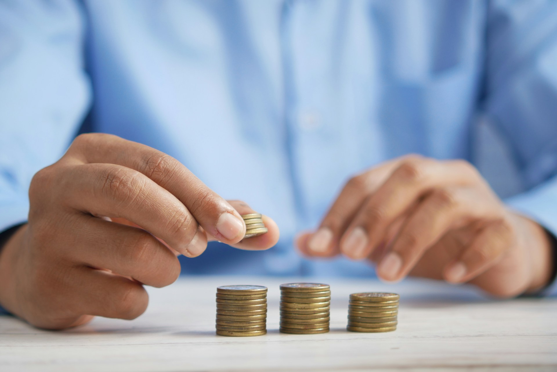 Man stacking coins on top of each other